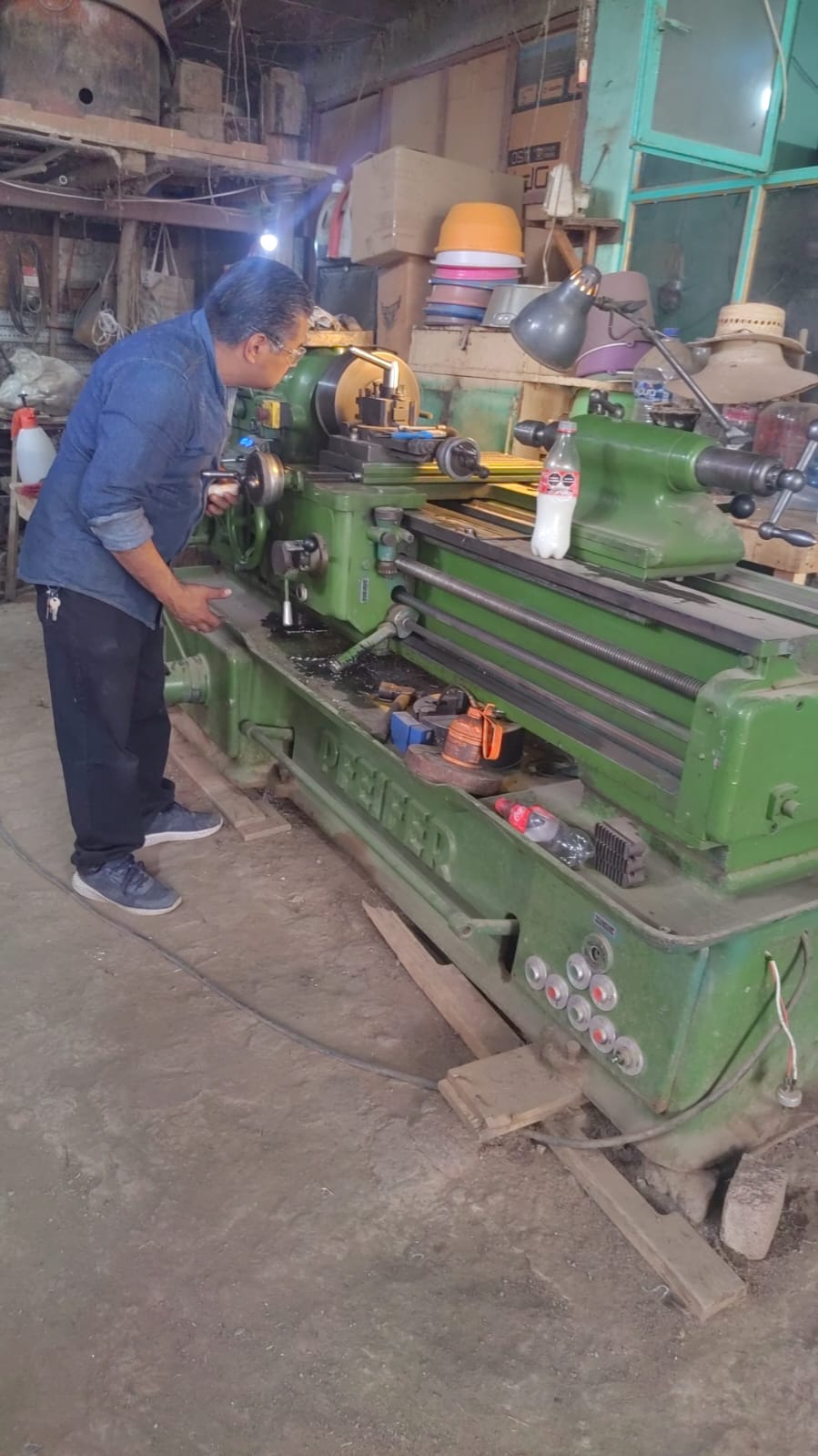 Técnico de Fénix reparando torno industrial en taller